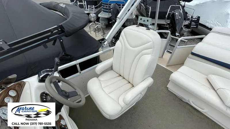 Slide: The Image of 2007 Harris Sunliner 220 boat interior with white captain's chair and steering wheel. - 4