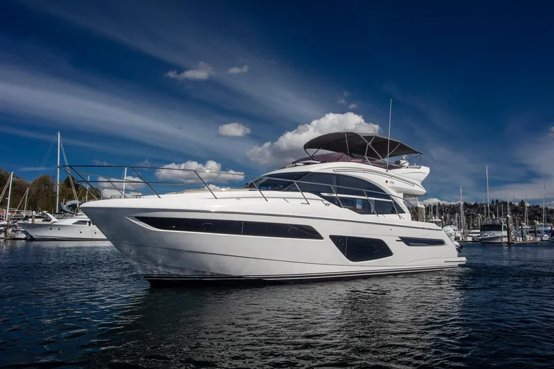 Slide: The Image of Luxury 2022 Princess F50 yacht docked under a clear blue sky. - 0