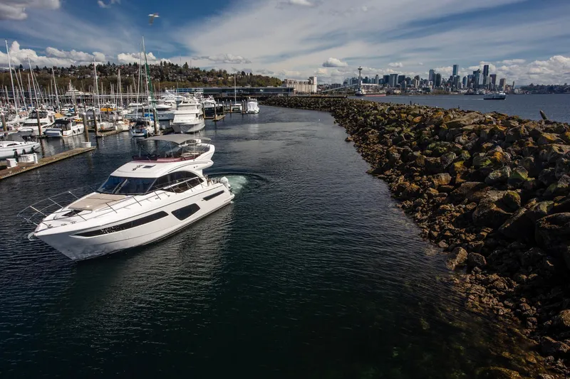 Slide: The Image of Luxury Princess F50 yacht cruising near marina with city skyline in background, 2022 model. - 1