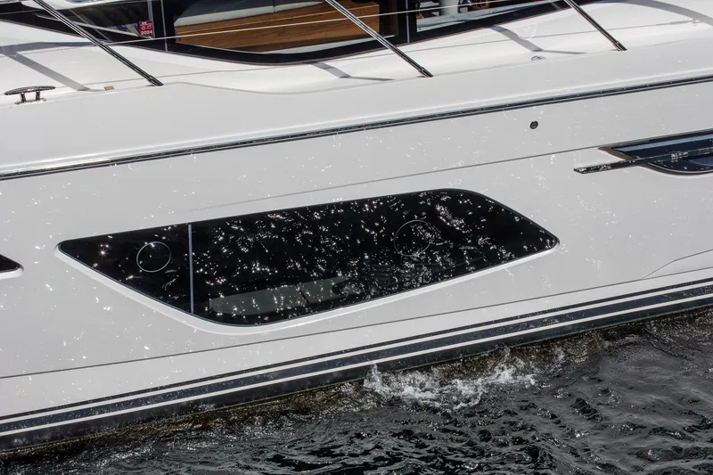 Slide: The Image of 2022 Princess F50 yacht side view with sleek windows and water reflections. - 12