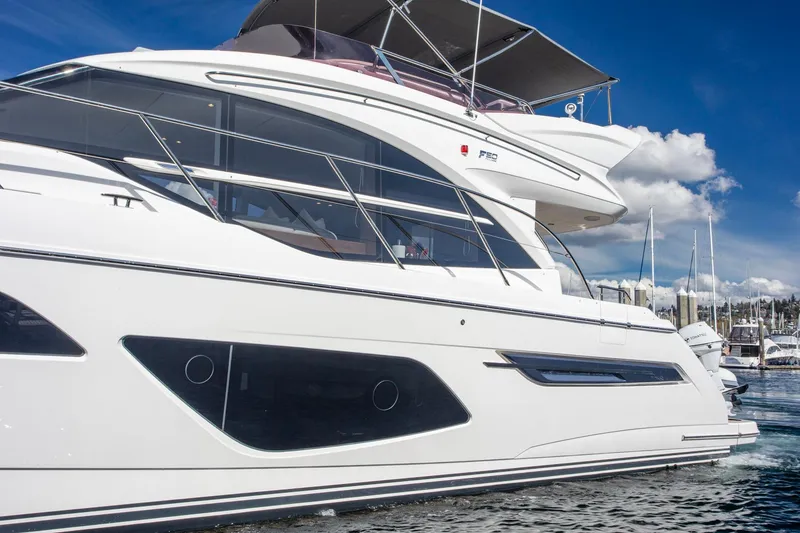 Slide: The Image of 2022 Princess F50 yacht docked at marina under clear blue sky. - 14