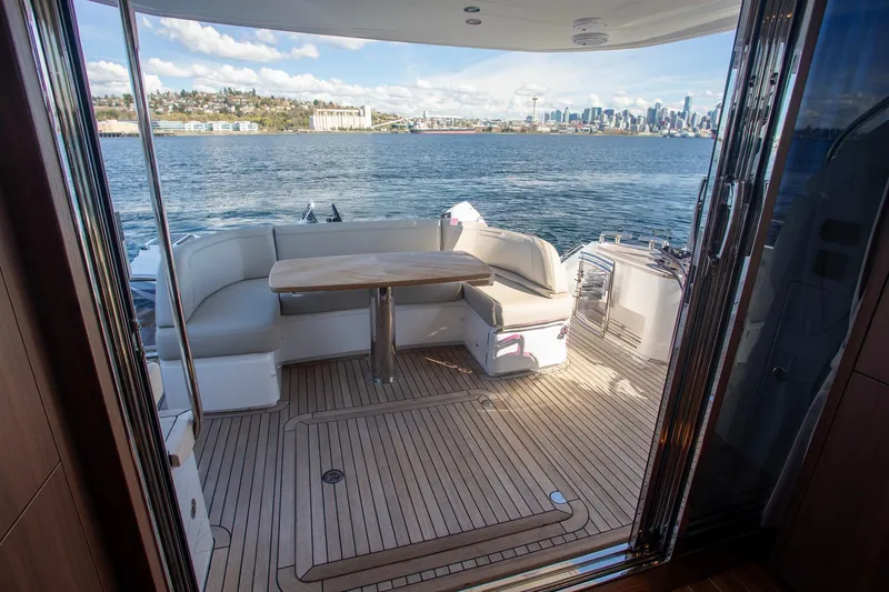 Slide: The Image of Luxurious 2022 Princess F50 yacht deck with seating, overlooking city skyline and water. - 19