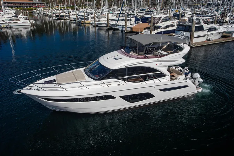 Slide: The Image of Luxury 2022 Princess F50 yacht docked in a marina, surrounded by other boats. - 2