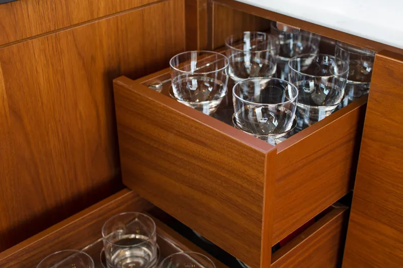 Slide: The Image of Wooden cabinet with glassware in a 2022 Princess F50 yacht interior. - 24
