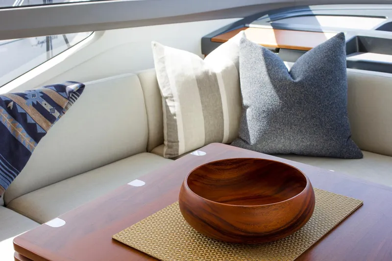 Slide: The Image of Luxurious interior of 2022 Princess F50 yacht with cushions and wooden bowl on table. - 27
