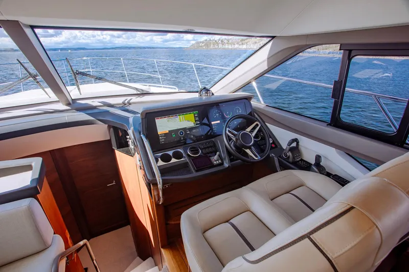 Slide: The Image of Luxurious 2022 Princess F50 yacht cockpit with modern navigation system and leather seating. - 32
