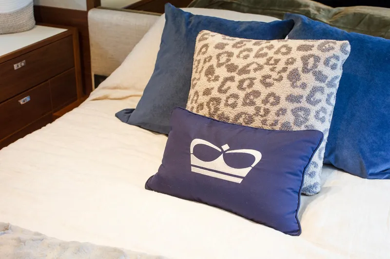 Slide: The Image of Luxurious bedding with patterned pillows on a 2022 Princess F50 yacht. - 36