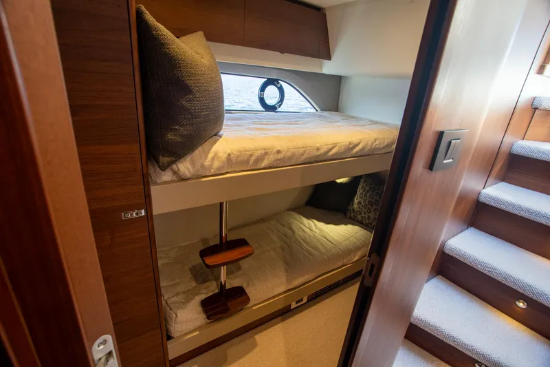 Slide: The Image of Bunk beds in 2022 Princess F50 yacht cabin with wooden interior and porthole window. - 43
