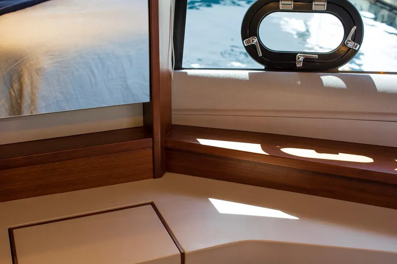 Slide: The Image of Interior of 2022 Princess F50 yacht with wooden accents and porthole view. - 45