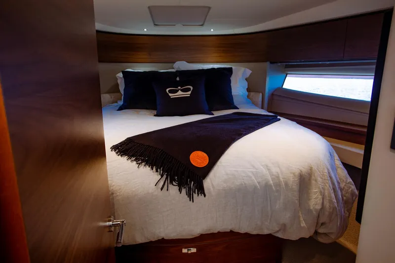 Slide: The Image of Luxurious bedroom interior of 2022 Princess F50 yacht with elegant bedding and wood accents. - 46
