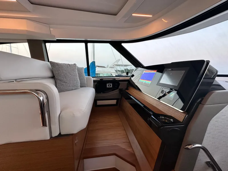 Slide: The Image of 2024 Tiara Yachts 48 LE interior with modern helm and luxurious seating. - 14