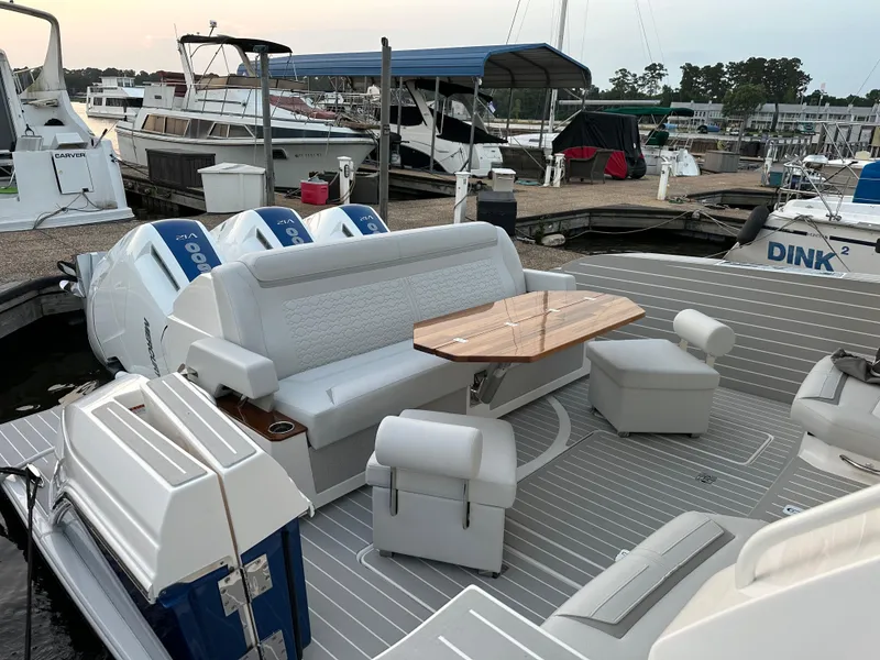 Slide: The Image of 2024 Tiara Yachts 48 LE with spacious deck and seating at marina. - 16