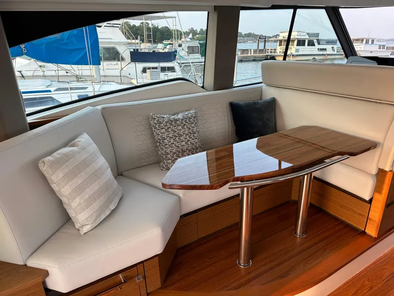 Slide: The Image of Luxurious interior of 2024 Tiara Yachts 48 LE with elegant seating and wooden table. - 4
