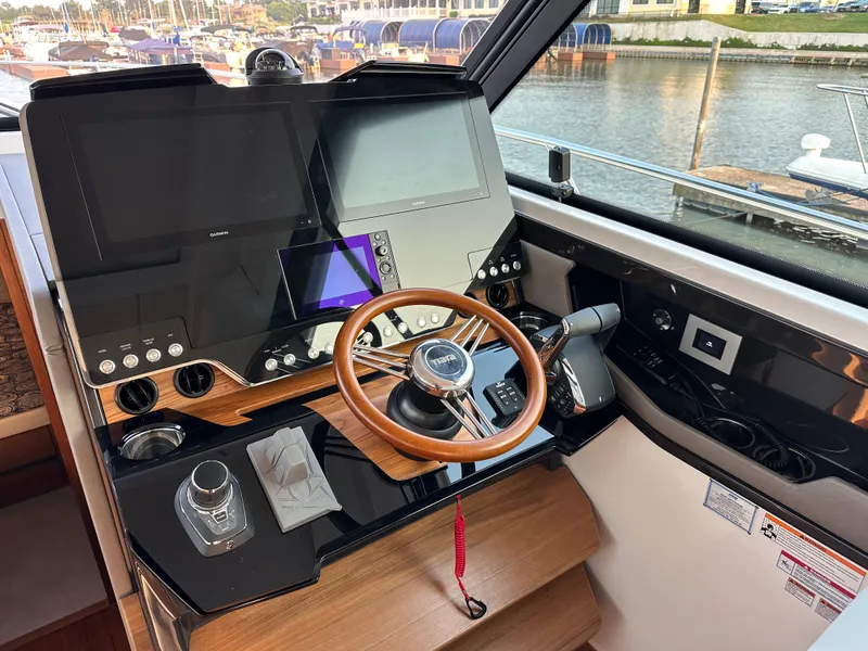 Slide: The Image of 2024 Tiara Yachts 48 LE helm with modern controls and dual displays. - 5