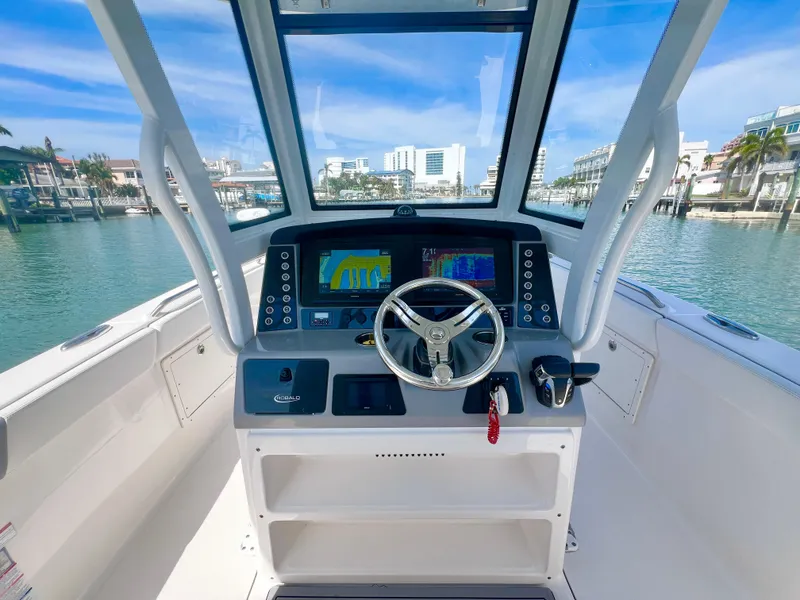 Slide: The Image of 2022 Robalo R272 Center Console boat helm with modern navigation system. - 16
