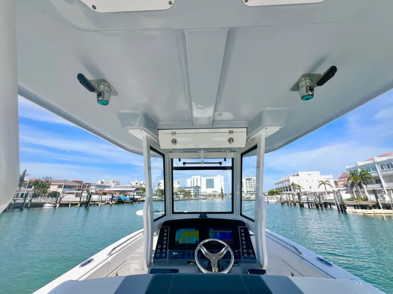 Slide: The Image of 2022 Robalo R272 Center Console boat on a scenic waterfront. - 17
