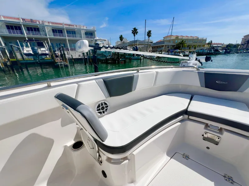 Slide: The Image of 2022 Robalo R272 Center Console boat interior with seating, docked at marina. - 23