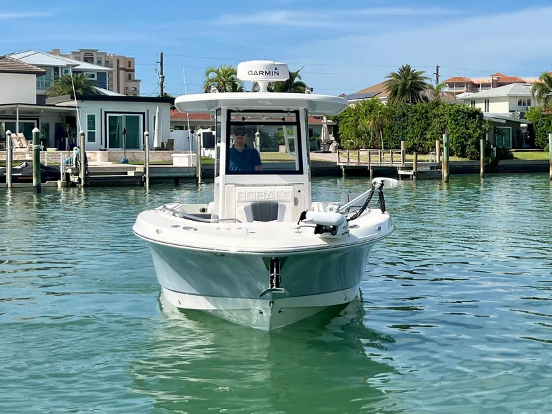 Slide: The Image of 2022 Robalo R272 Center Console boat on calm water near docks and waterfront homes. - 6