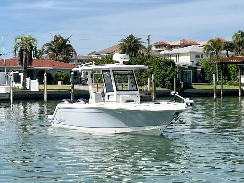 Slide: The Image of 2022 Robalo R272 Center Console boat on calm water near residential area. - 7
