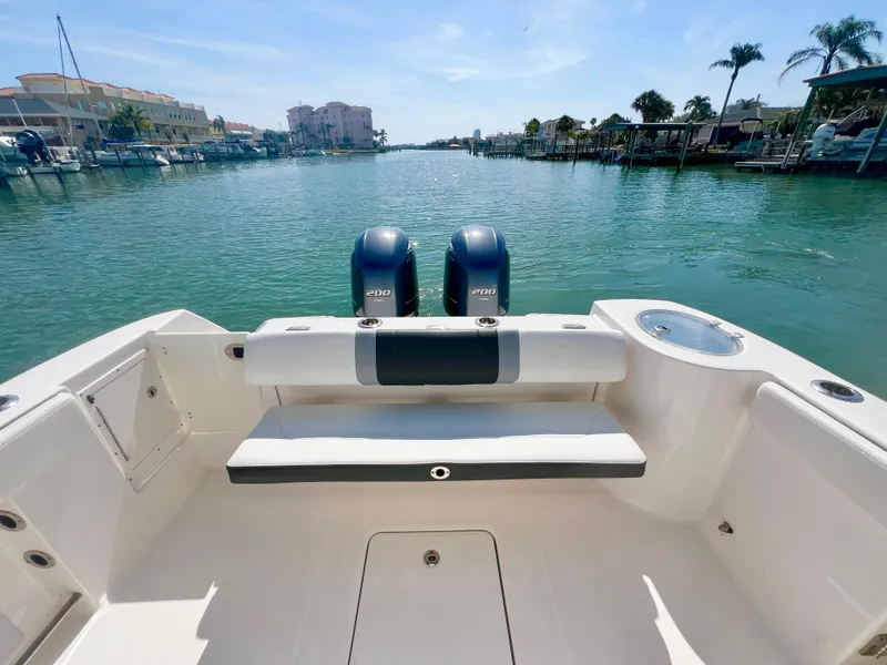 Slide: The Image of 2022 Robalo R272 Center Console boat with dual engines on a sunny waterway. - 9