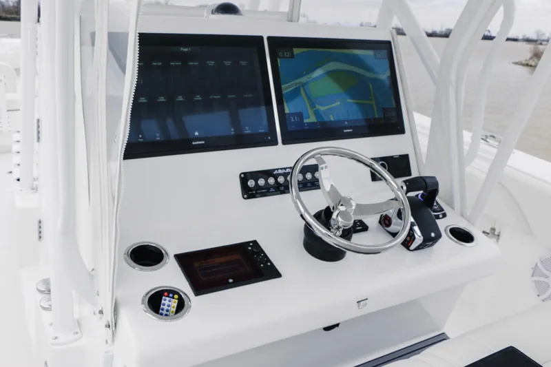Slide: The Image of 2024 SeaHunter 35 Tournament boat dashboard with dual screens and steering wheel. - 12