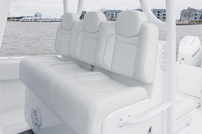 Slide: The Image of 2024 SeaHunter 35 Tournament boat with white cushioned seating, docked by the water. - 13