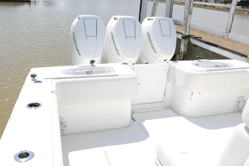 Slide: The Image of 2024 SeaHunter 35 Tournament boat with triple Mercury engines docked by the water. - 16