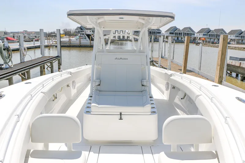 Slide: The Image of 2024 SeaHunter 35 Tournament boat with sleek white interior at a marina. - 17