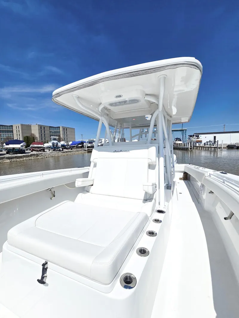 Slide: The Image of 2024 SeaHunter 35 Tournament boat with sleek design, docked under clear blue sky. - 18