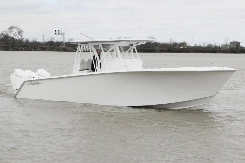 Slide: The Image of 2024 SeaHunter 35 Tournament boat cruising on a calm waterway. - 4