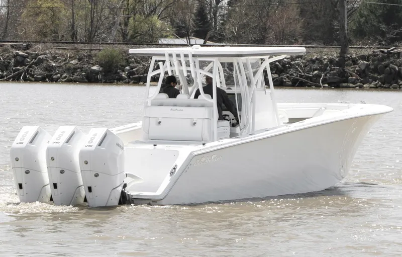 Slide: The Image of 2024 SeaHunter 35 Tournament boat with triple engines on a calm river. - 5