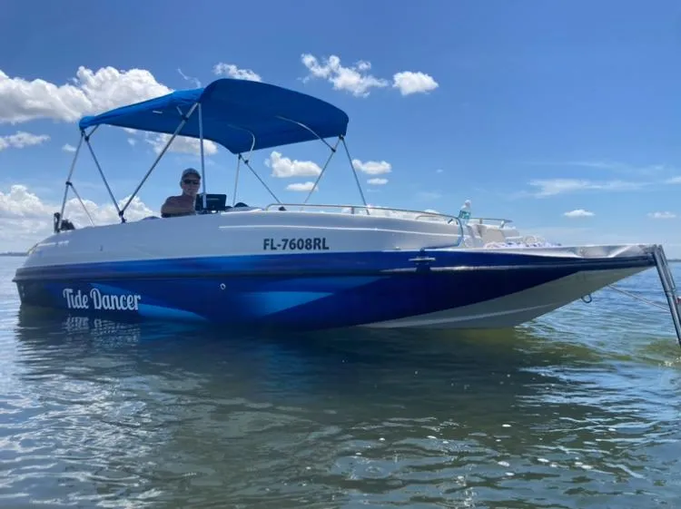 The Image of 2018 Starcraft Limited 2000 OB Fish boat with blue canopy on water. - 0
