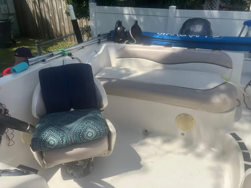 Slide: The Image of 2018 Starcraft Limited 2000 OB Fish boat interior with cushioned seating and fishing gear. - 10