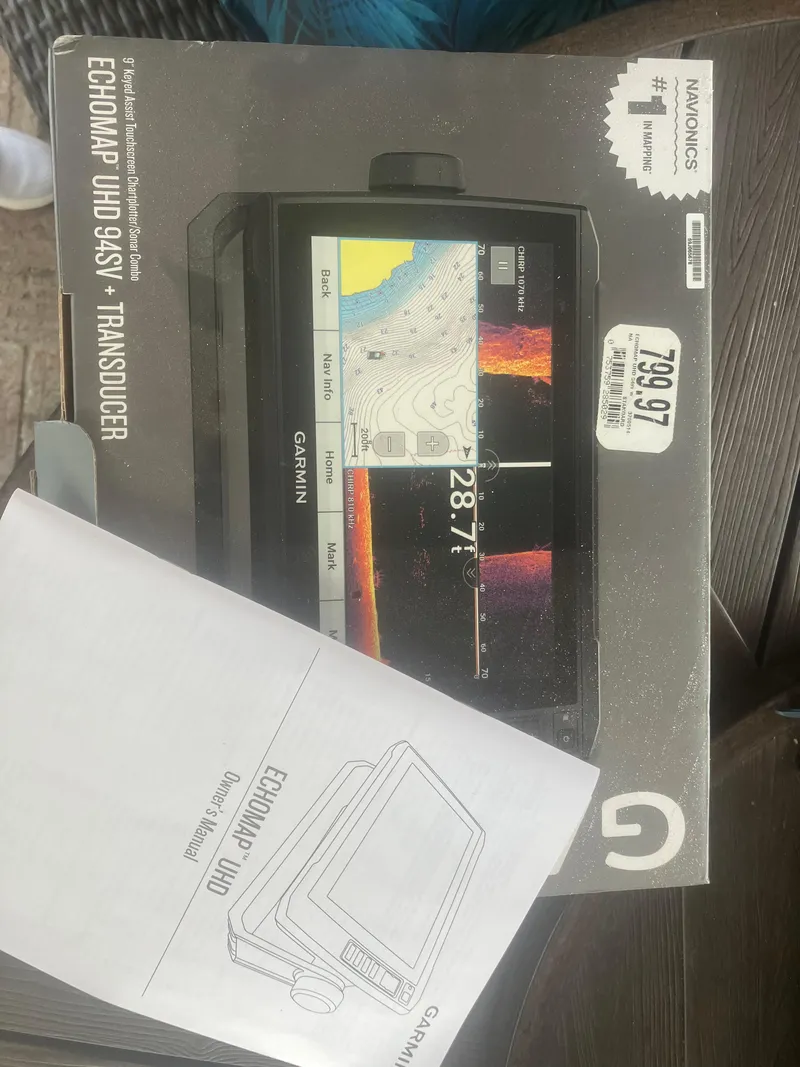 Slide: The Image of Garmin ECHOMAP UHD 94sv Transducer box and manual on a wooden surface. - 17