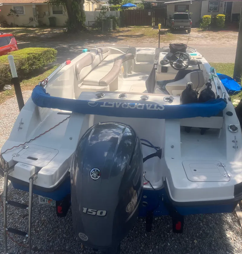 Slide: The Image of 2018 Starcraft Limited 2000 OB Fish boat with Yamaha 150 engine, parked on gravel. - 5