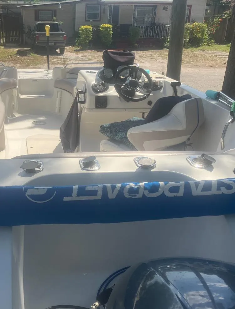 Slide: The Image of 2018 Starcraft Limited 2000 OB Fish boat interior with steering wheel and seating. - 7