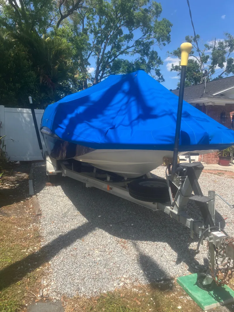 Slide: The Image of 2018 Starcraft Limited 2000 OB Fish boat covered with a blue tarp on a trailer. - 8