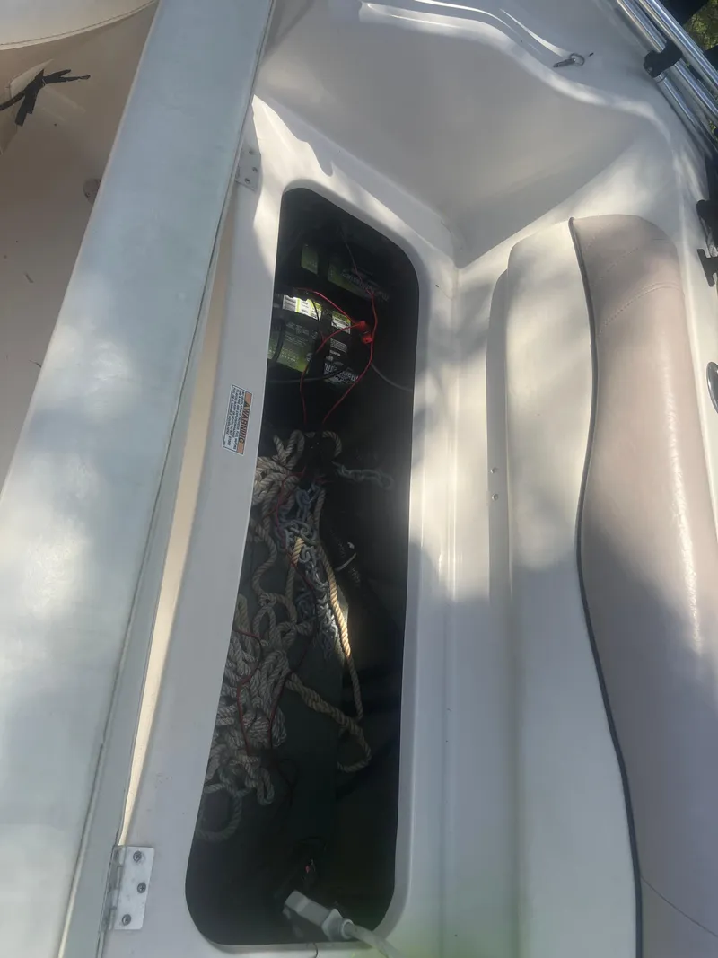 Slide: The Image of 2018 Starcraft Limited 2000 OB Fish boat storage compartment with ropes and equipment. - 9