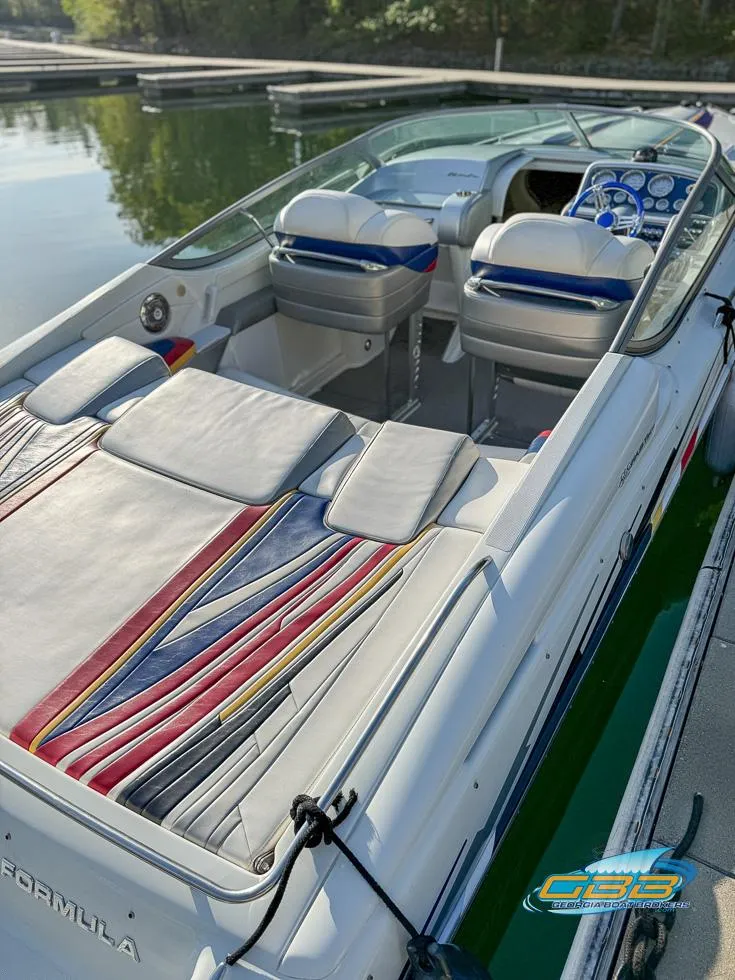 Slide: The Image of 2008 Formula 292 FASTech boat with colorful interior, docked on calm water. - 17