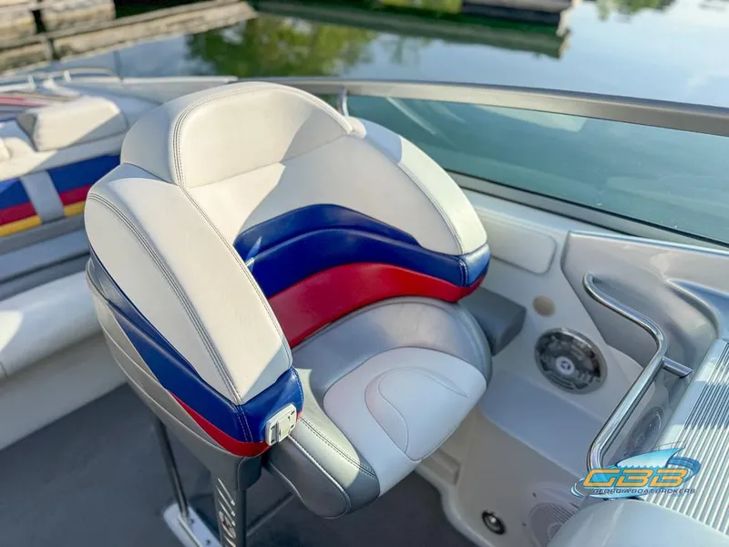 Slide: The Image of 2008 Formula 292 FASTech boat seat with red, blue, and white design near water. - 21