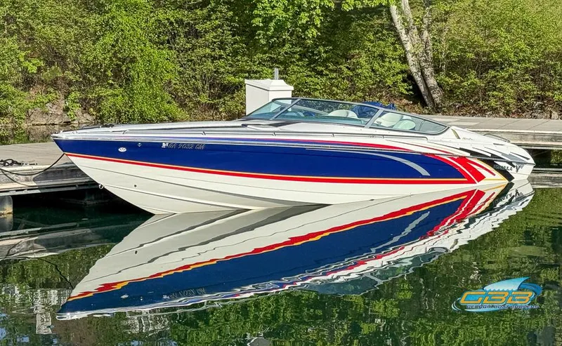 Slide: The Image of 2008 Formula 292 FASTech boat with vibrant red, white, and blue design docked on calm water. - 4
