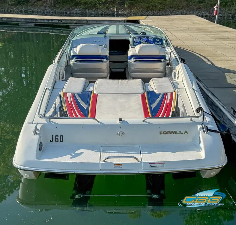 Slide: The Image of 2008 Formula 292 FASTech boat docked, rear view, vibrant seating, calm water. - 7