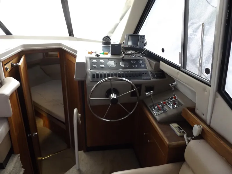 Slide: The Image of 2000 Bayliner 4087 Aft Cabin Motoryacht helm with steering wheel and navigation equipment. - 11
