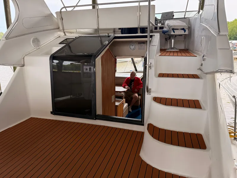 Slide: The Image of 2000 Bayliner 4087 Aft Cabin Motoryacht interior with wooden flooring and staircase. - 12