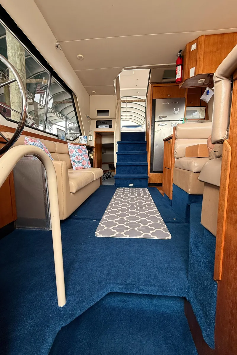 Slide: The Image of Interior of 2000 Bayliner 4087 Aft Cabin Motoryacht with blue carpet and cozy seating. - 15