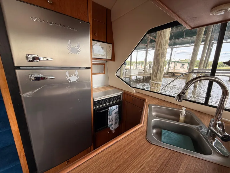 Slide: The Image of Bayliner 4087 Aft Cabin Motoryacht 2000 kitchen with stainless steel appliances and dual sink. - 17