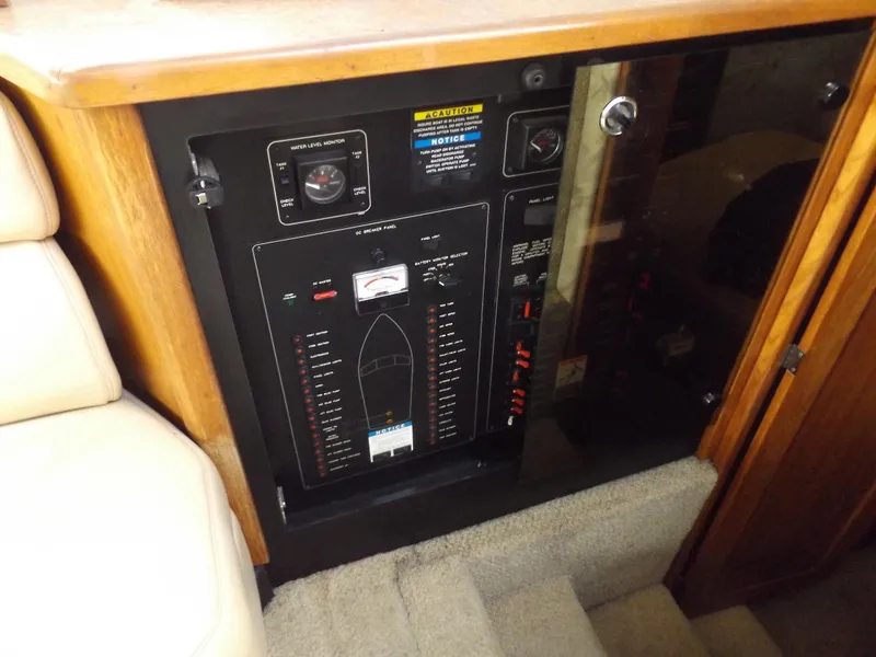 Slide: The Image of Electrical panel inside 2000 Bayliner 4087 Aft Cabin Motoryacht, featuring control switches and gauges. - 23