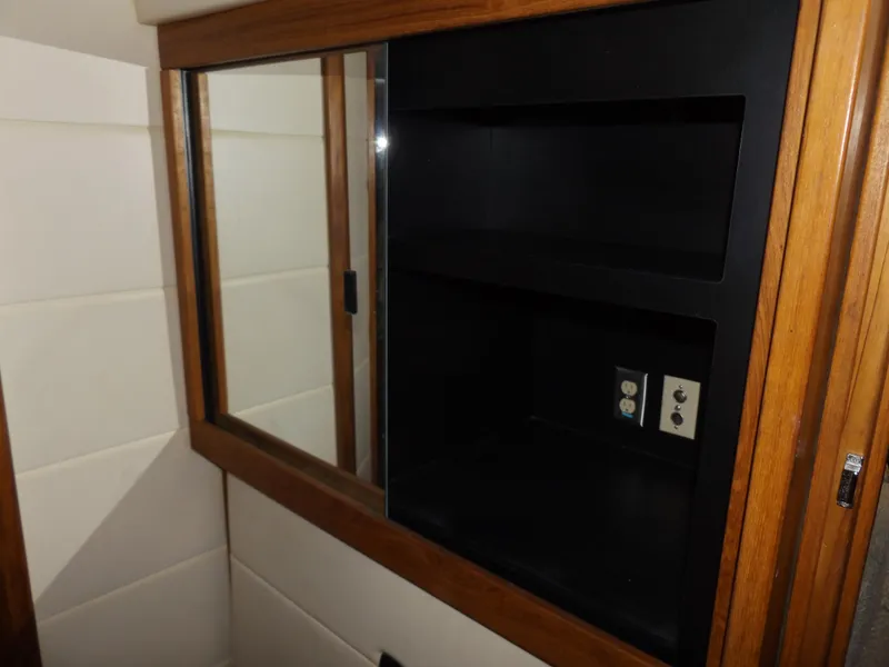 Slide: The Image of Interior cabinet with shelves in 2000 Bayliner 4087 Aft Cabin Motoryacht. - 25
