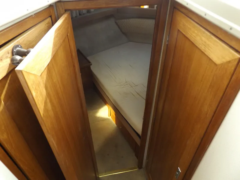 Slide: The Image of Bayliner 4087 Aft Cabin Motoryacht 2000 interior with wooden doors and cozy sleeping area. - 26