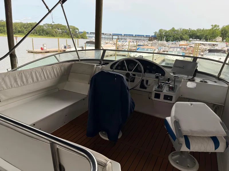 Slide: The Image of 2000 Bayliner 4087 Aft Cabin Motoryacht helm with marina view in background. - 31